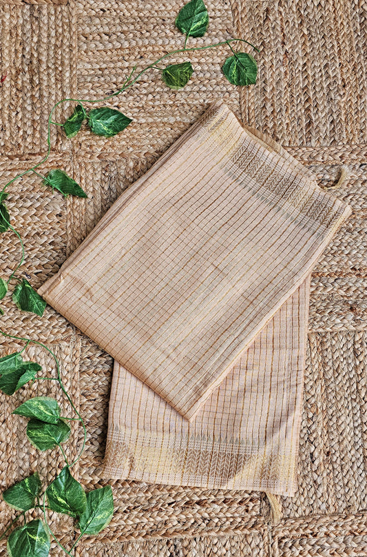 Two woven placemats on a textured surface with green leaves.