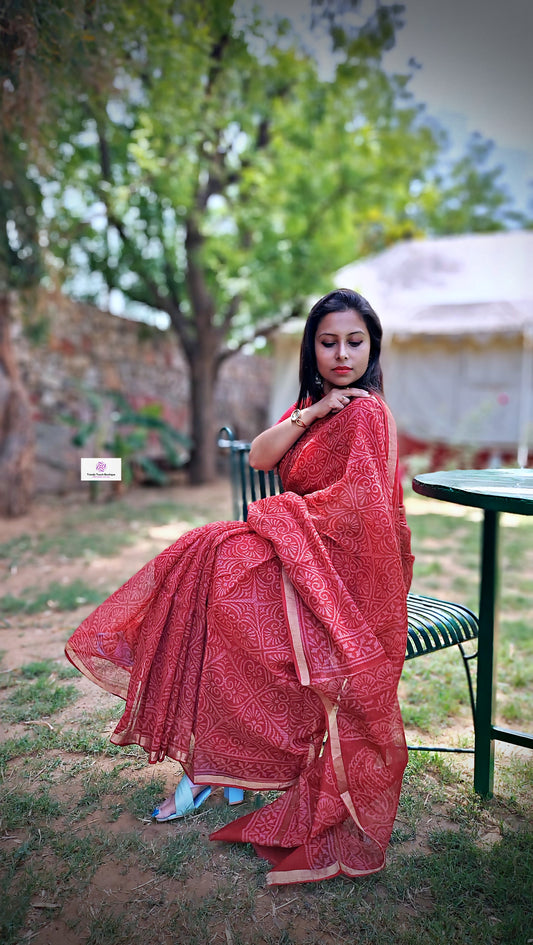Hand block printed maroon Kota Doria saree with natural dyes, floral and paisley patterns, lightweight and skin-friendly.